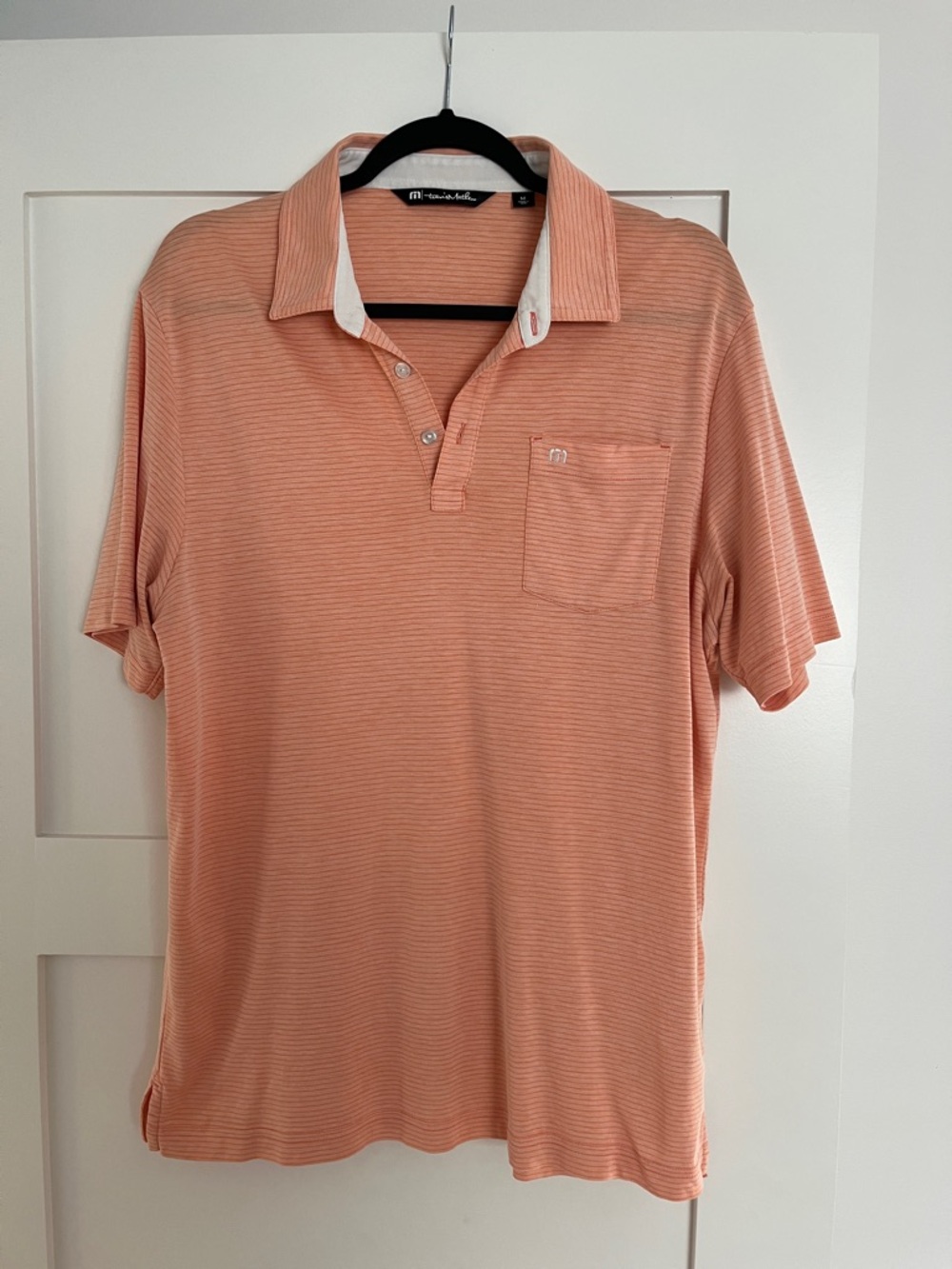 Travis Mathew Men’s medium golf polo orange/coral color with small white stripes